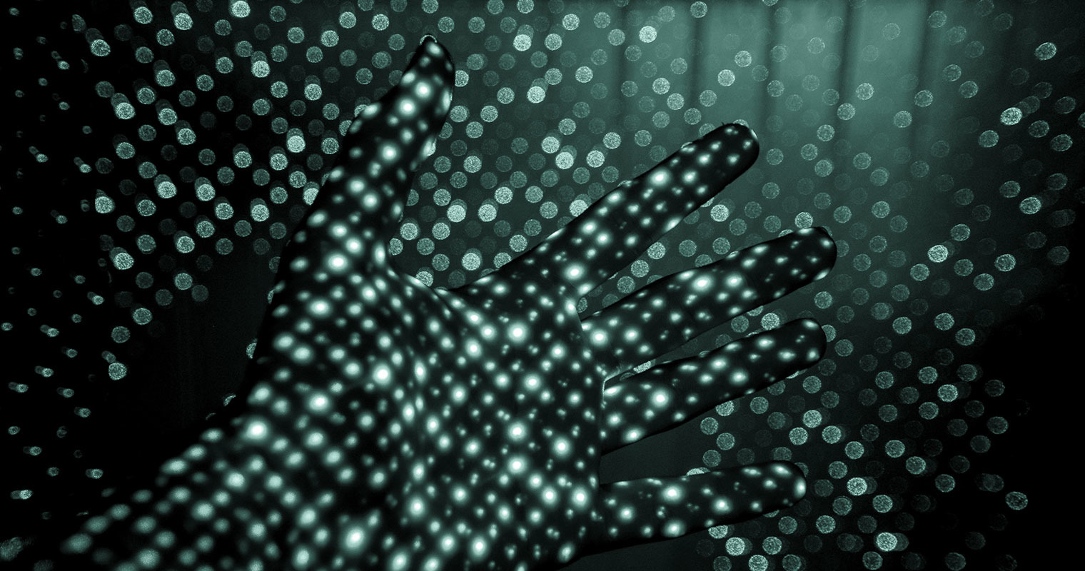 Gray and green dots on dark background